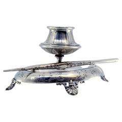 Silver inkwell with chiseled base, four support feet and pen