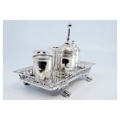 Silver inkwell with cut-out grid, pen holders, bell & claw-shaped feet