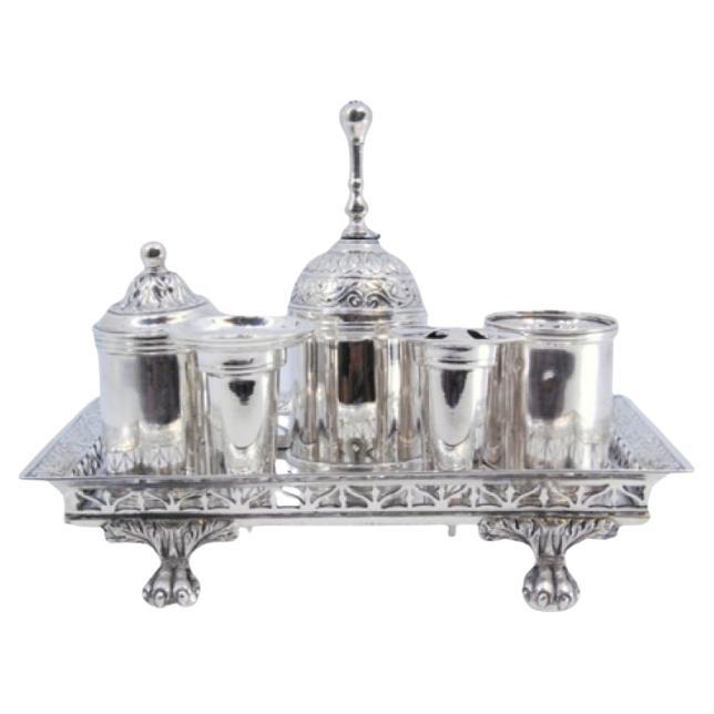 Silver inkwell with cut-out grid, pen holders, bell 
claw-shaped feet