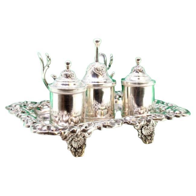 Silver inkwell with floral cutouts, two reservoirs, bell 
relief feet
