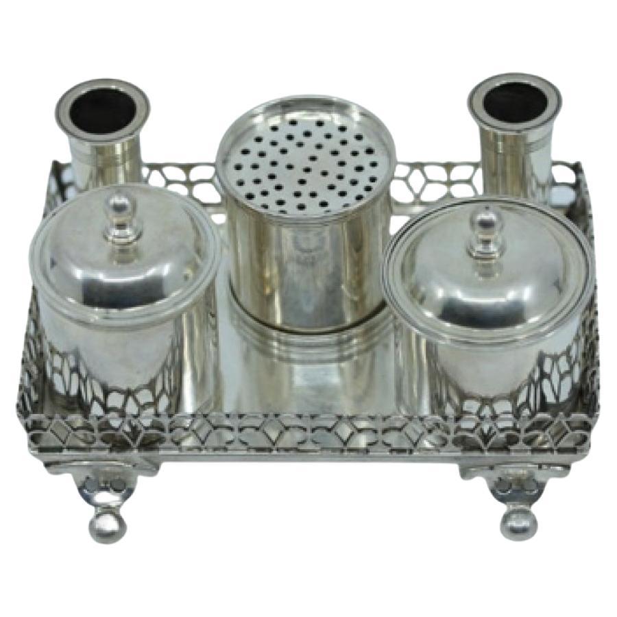 Silver inkwell with grid, two reservoirs
four half-ball feet