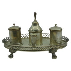 Silver inkwell with grid, two reservoirs, pen holders
claw feet