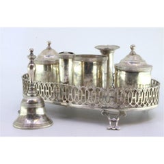 Silver inkwell with grid, two tanks, pen holder & four hollow feet