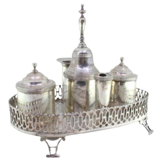 Silver inkwell with grid, two tanks, pen holder 
four hollow feet