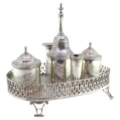 Silver inkwell with grid, two tanks, pen holder 
four hollow feet