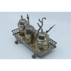 Silver inkwell with rack, bell, two tanks, pen holder and set on four claw feet