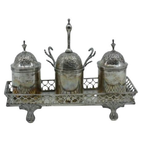Silver inkwell with rack, bell, two tanks, pen holder and set on four claw feet