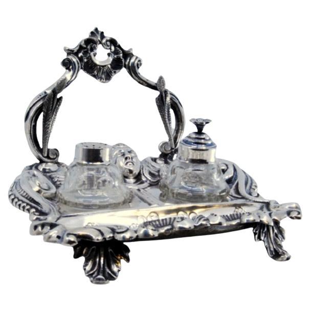 Silver inkwell with reliefs, two containers 
palm-shaped feet