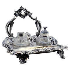 Silver inkwell with reliefs, two containers 
palm-shaped feet