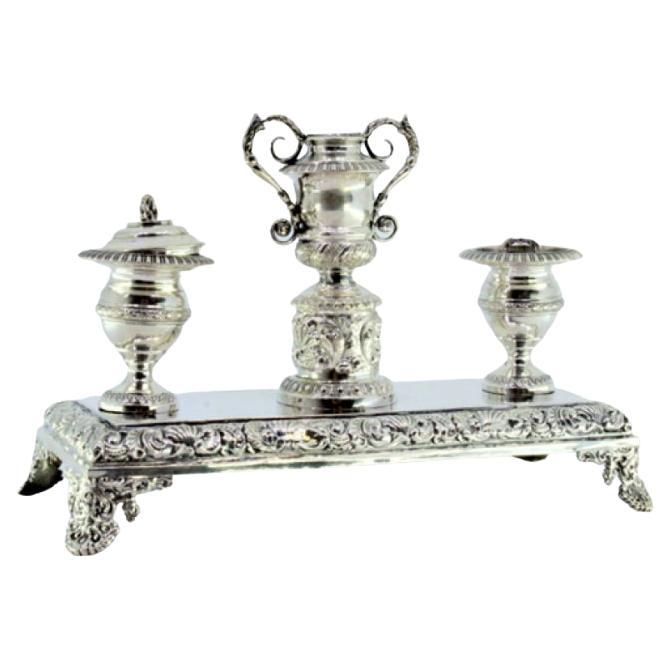 Silver inkwell with reliefs, two reservoirs 
four cut-out feet