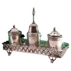 Silver inkwell with tanks, bell, square base 
four openwork feet