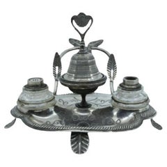 Silver inkwell with two tanks and relief applications with a bell