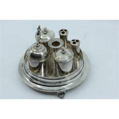 Silver inkwell with two tanks, bell, pen holder and set on three raised feet