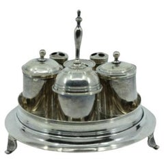 Silver inkwell with two tanks, bell, pen holder and set on three raised feet
