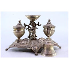 Silver inkwell with two tanks, Putti bell support & cut-out feet