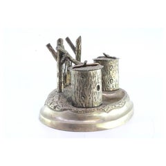Silver inkwell with two trunk-shaped reservoirs, pen holder and raised base