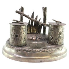 Silver inkwell with two trunk-shaped reservoirs, pen holder and raised base