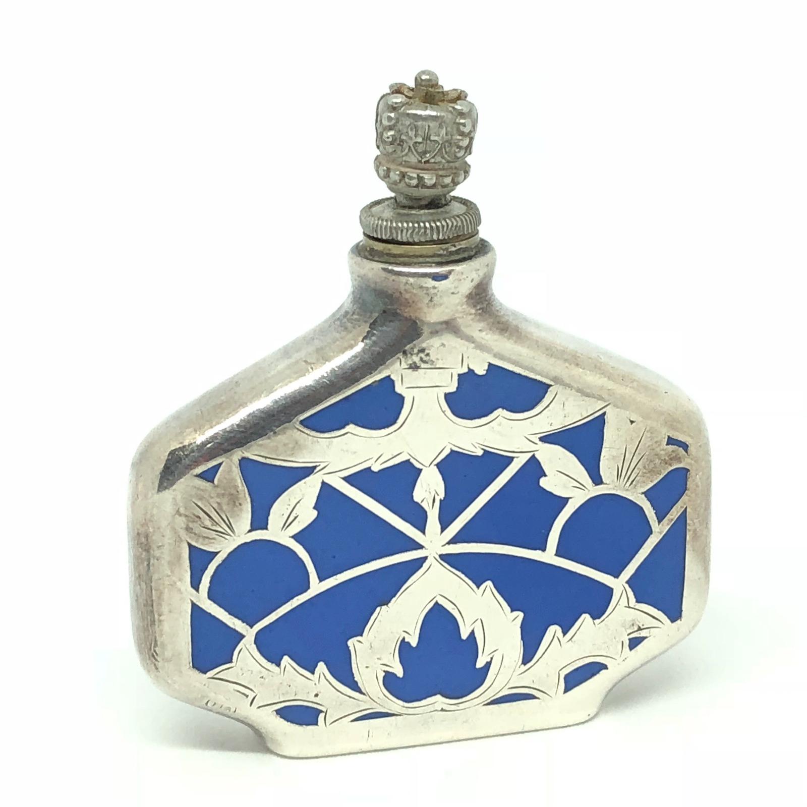Classic early 20th century silver inlay perfume bottle with blue china porcelain. Marked with makers mark and 1000 for the
silver content. Very good vintage condition, consistent with age and use.