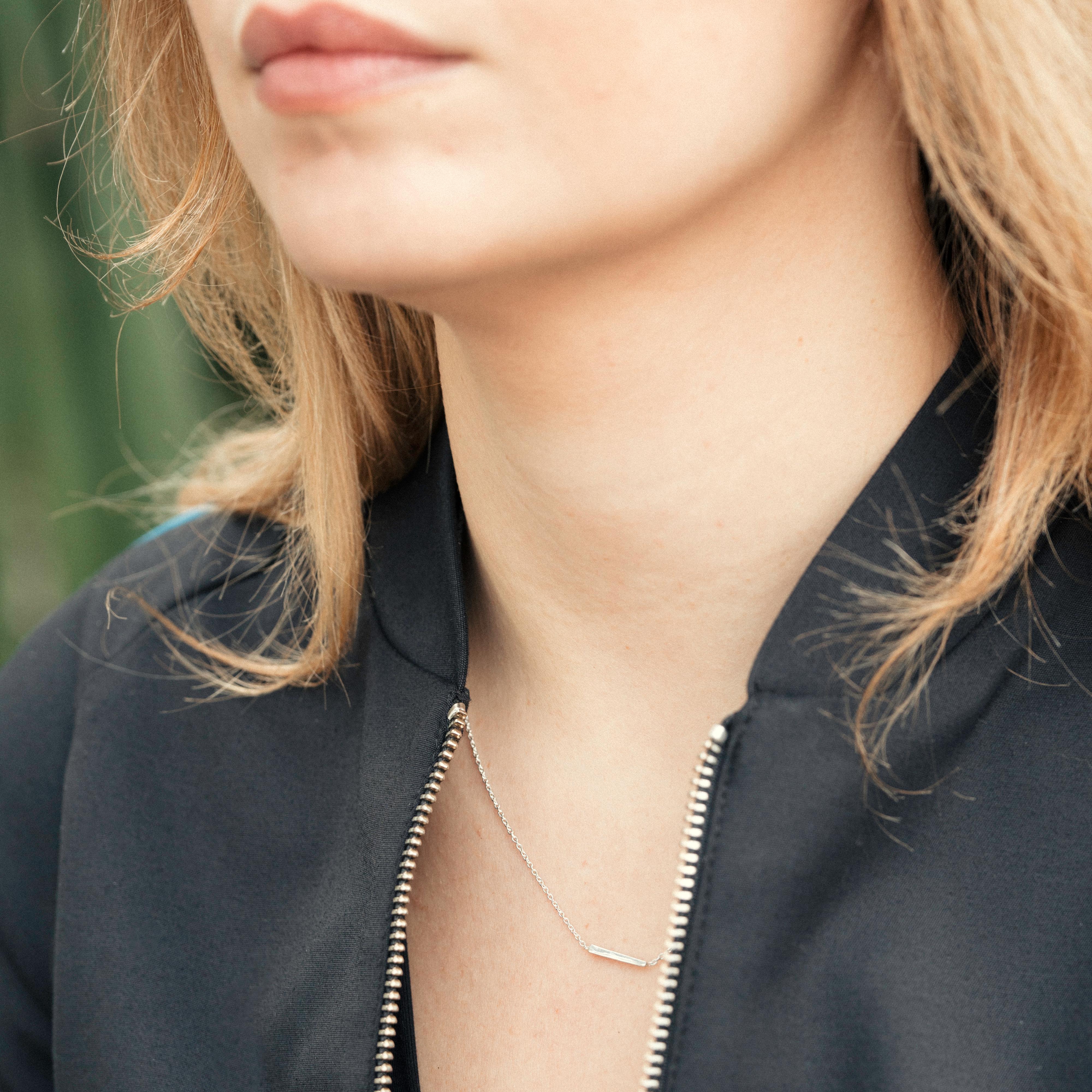 The Interval Bar Necklace shifts from square to triangle end to end. Dynamic and easy, this necklace is a study in subtle motion. A delicate but sturdy 16”/ 1 mm Italian chain makes this piece durable for everyday wear. Crafted in solid sterling