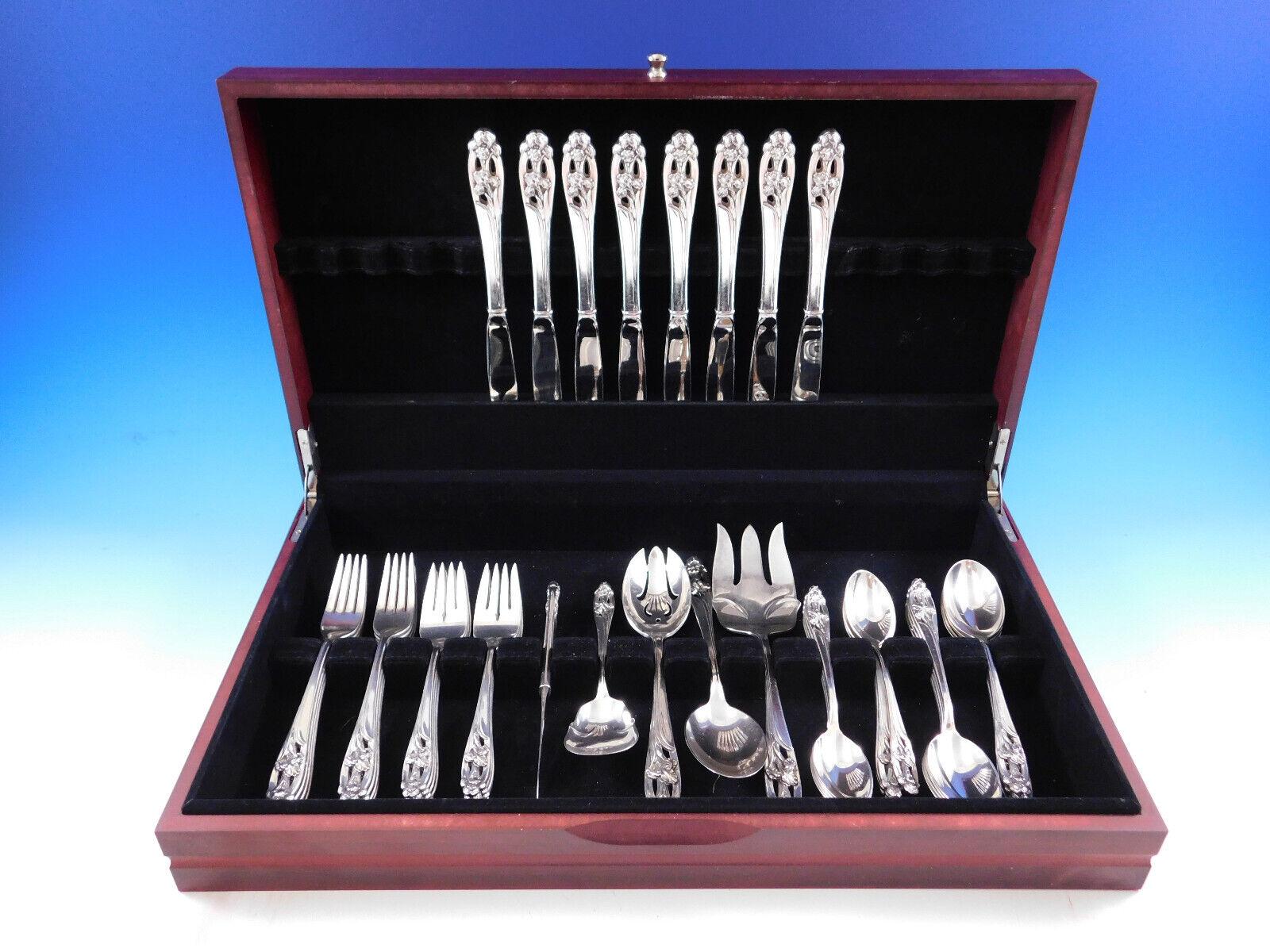 Gorgeous Silver Iris by International sterling silver flatware set with pierced handles and high relief iris detailing - 45 pieces. This set includes:
8 Knives, 9 1/4