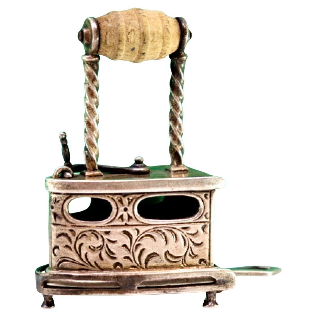 Silver iron w/ applications 
reliefs, wooden handle 
three-legged cut-out rest For Sale