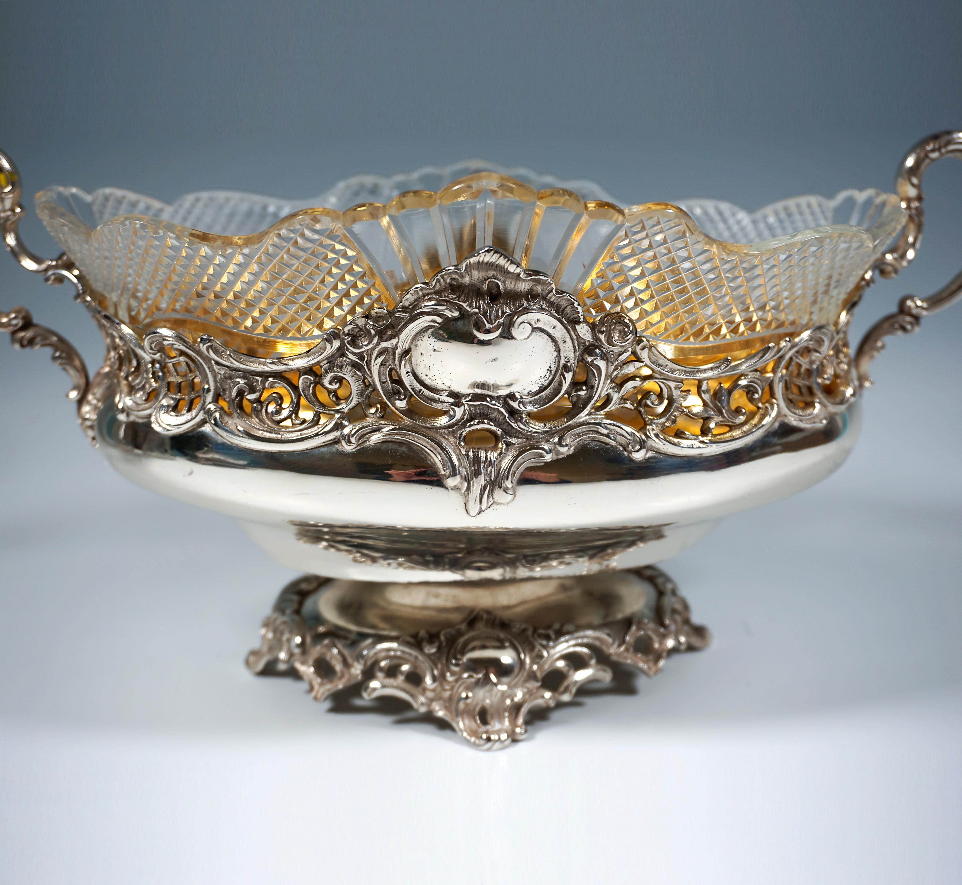 Elegant, festive silver vessel in an oval shape on a stepped base with projecting, pierced rocaille elements, pierced decoration also on the upper rim of the wall with irregular edges, front and back panels surrounded by volutes and rocailles, the