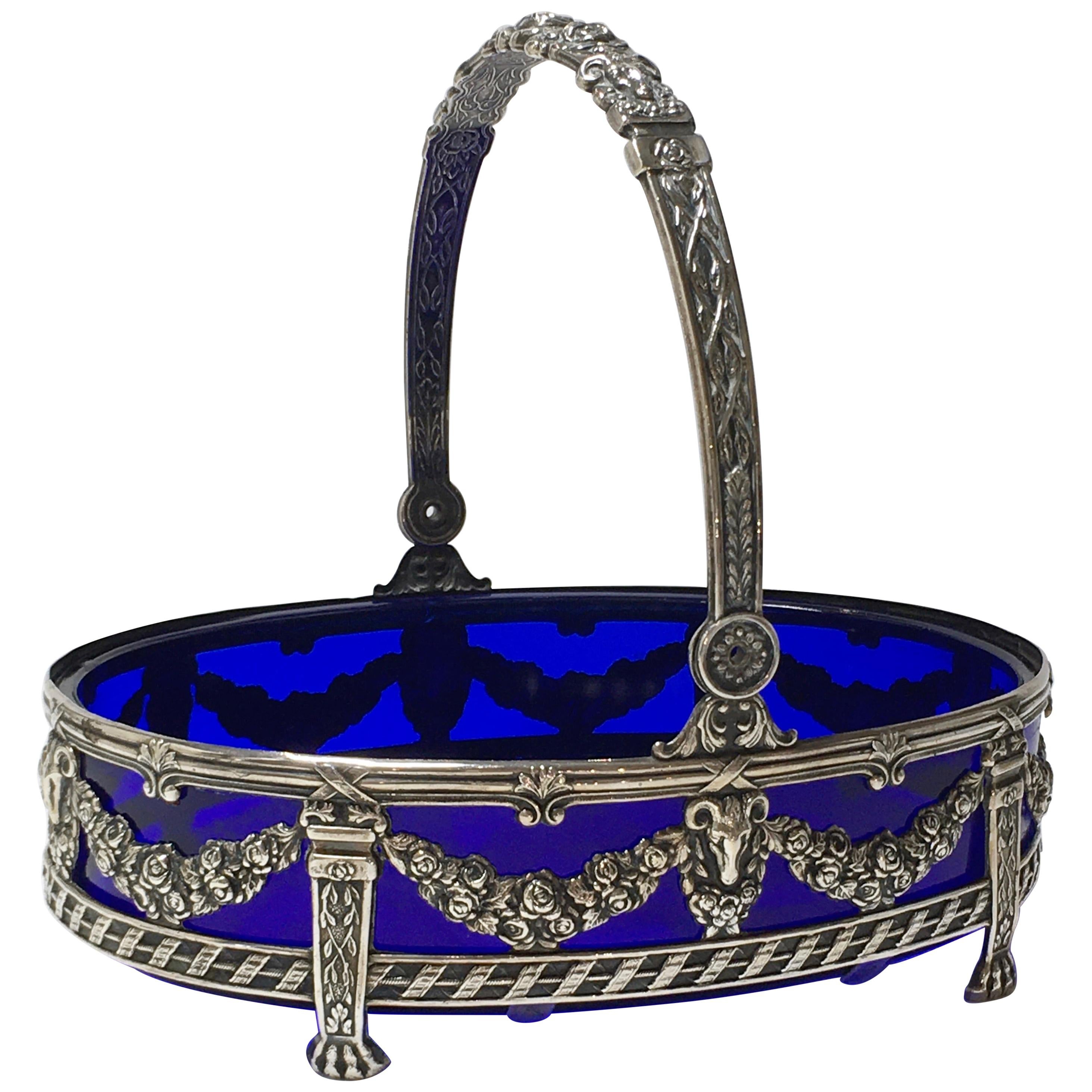 Solid Silver jardinière with blue glass bowl. Made in the Netherlands, 1960
Oval shape, empire decor and decorated hinged handle. The length of this beautiful bowl is 22 centimeters, the height is 24 centimeters. Made for Bos & Sons Amsterdam, The