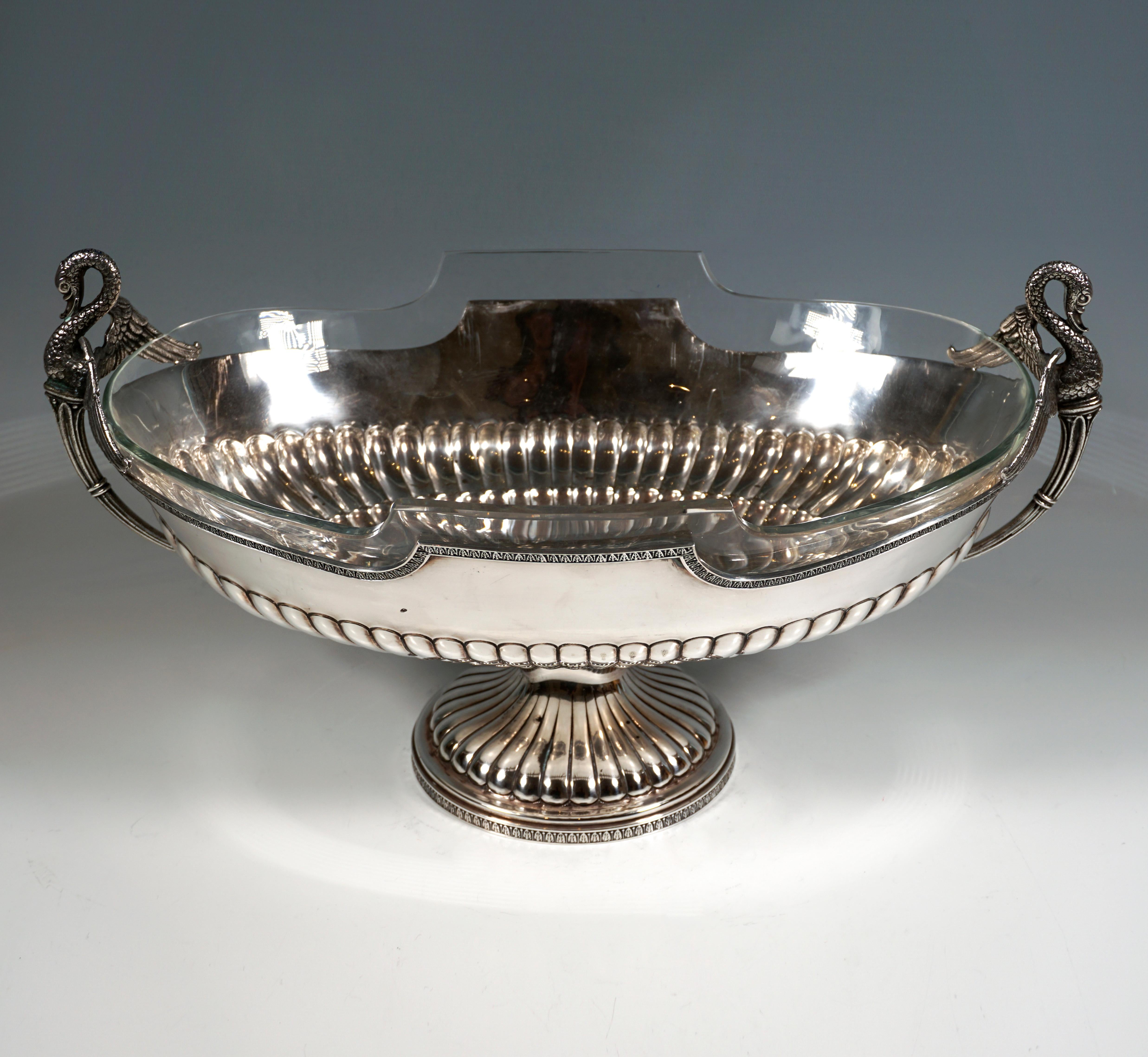 Solid silver vessel in an oval basic form with a wide, bulbous body, offset, domed, round base with hump decoration and palmette decorative strip on the outside of the base ring, hump decoration in the lower half of the vessel body in one step,