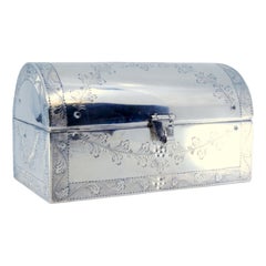 Silver jewelry box in the shape of a chest with engraved plant motifs