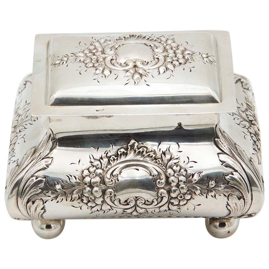 Silver jewelry box with embossed floral motifs