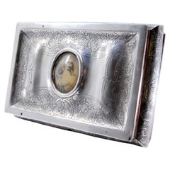 Silver jewelry box with plant engravings and antique-lady card