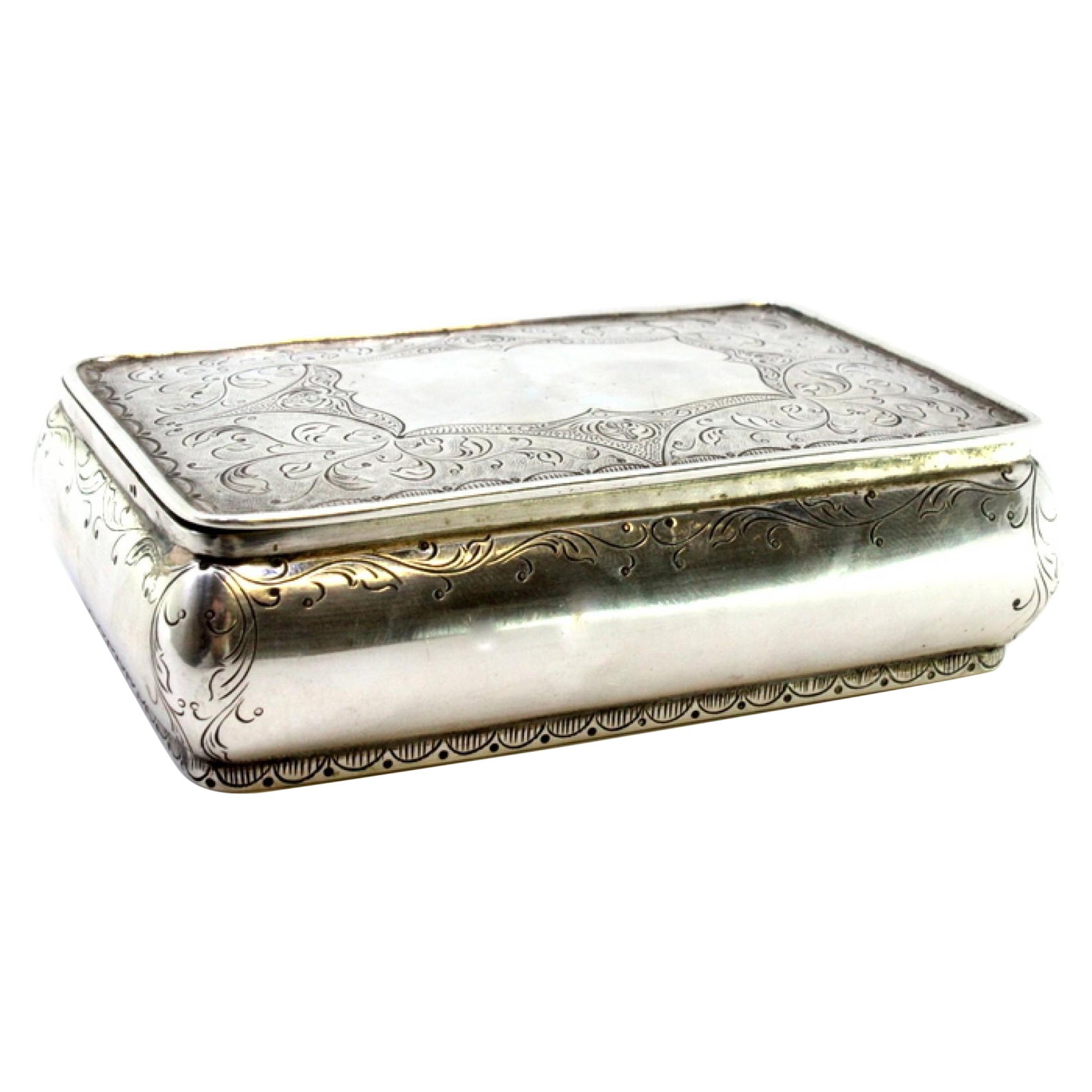 Silver jewelry box with plant engravings and central monogram plaque