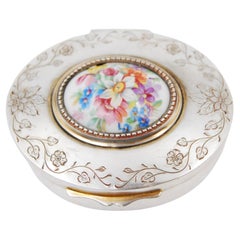 Silver jewelry box with plant engravings and porcelain floral lid
