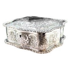 Silver jewelry box with plant engravings, monogram and red velvet interior
