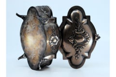 Silver jewelry box with plant-relief appliqués, four feet and hinged lid