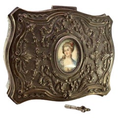 Silver jewelry box with raised florals and antique-lady card, keyed lid
