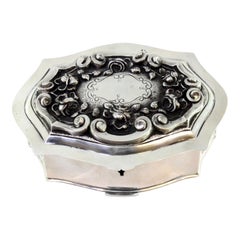 Silver jewelry box with raised florals, monogram and maroon velvet interior