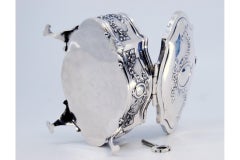 Silver jewelry box with ribbons, monogram and four palm-foot supports