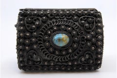 Silver jewelry box with rosette lining and cabochon on hinged lid