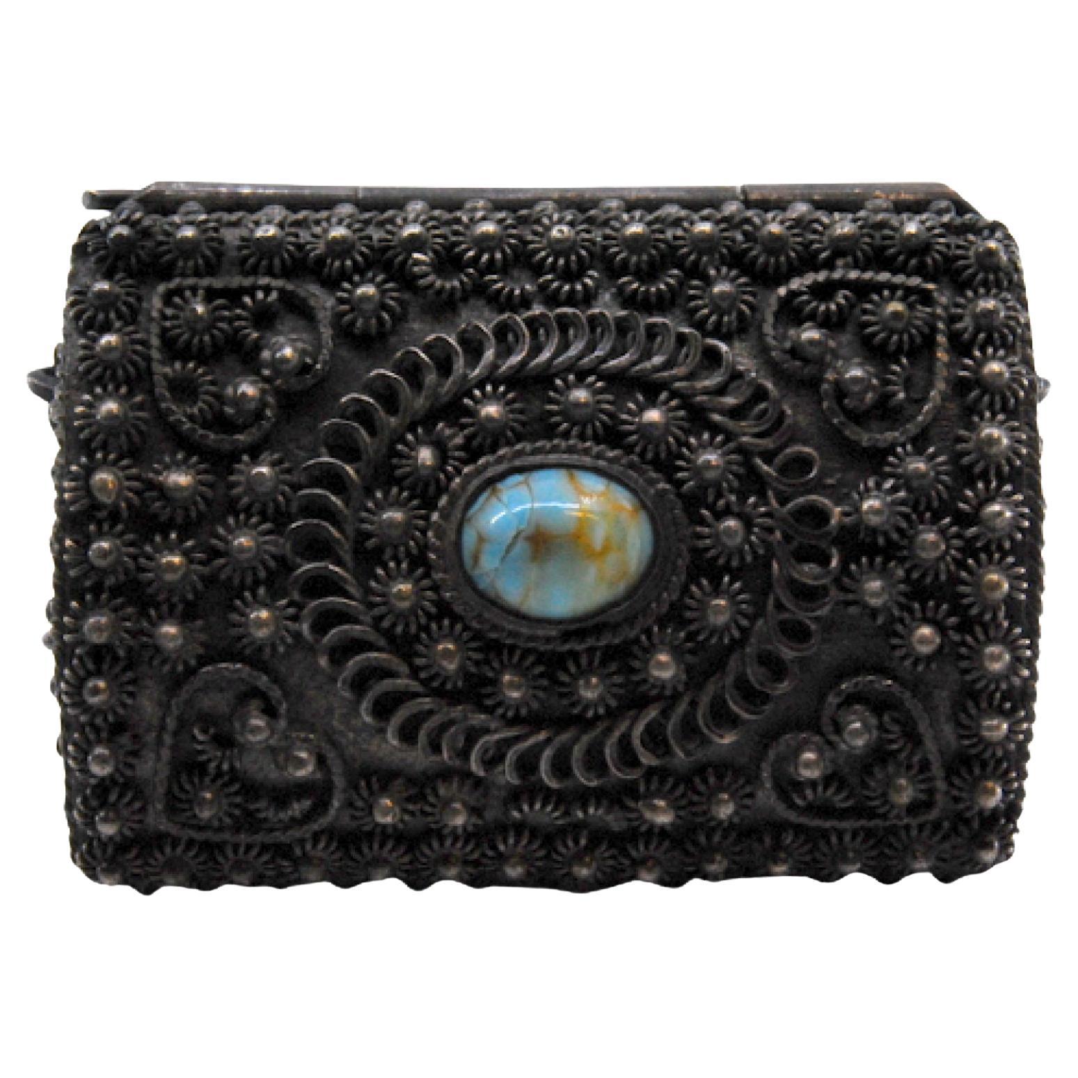 Silver jewelry box with rosette lining and cabochon on hinged lid