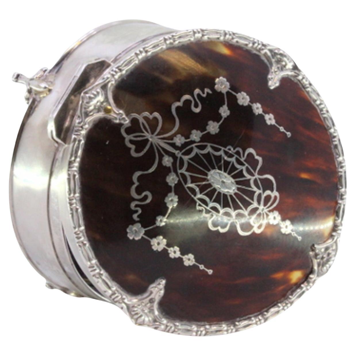 Silver jewelry box with tortoiseshell lid, friezes and fleur-de-lis feet