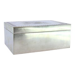 Silver jewelry box with two embossed hearts and phrase “Love is repaid…”