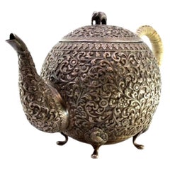 Silver kettle with Arabic-style floral reliefs, stuffed handle and bird feet