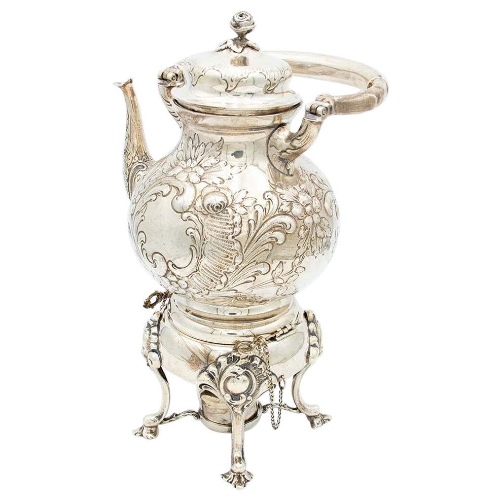 Silver kettle with embossed floral motifs