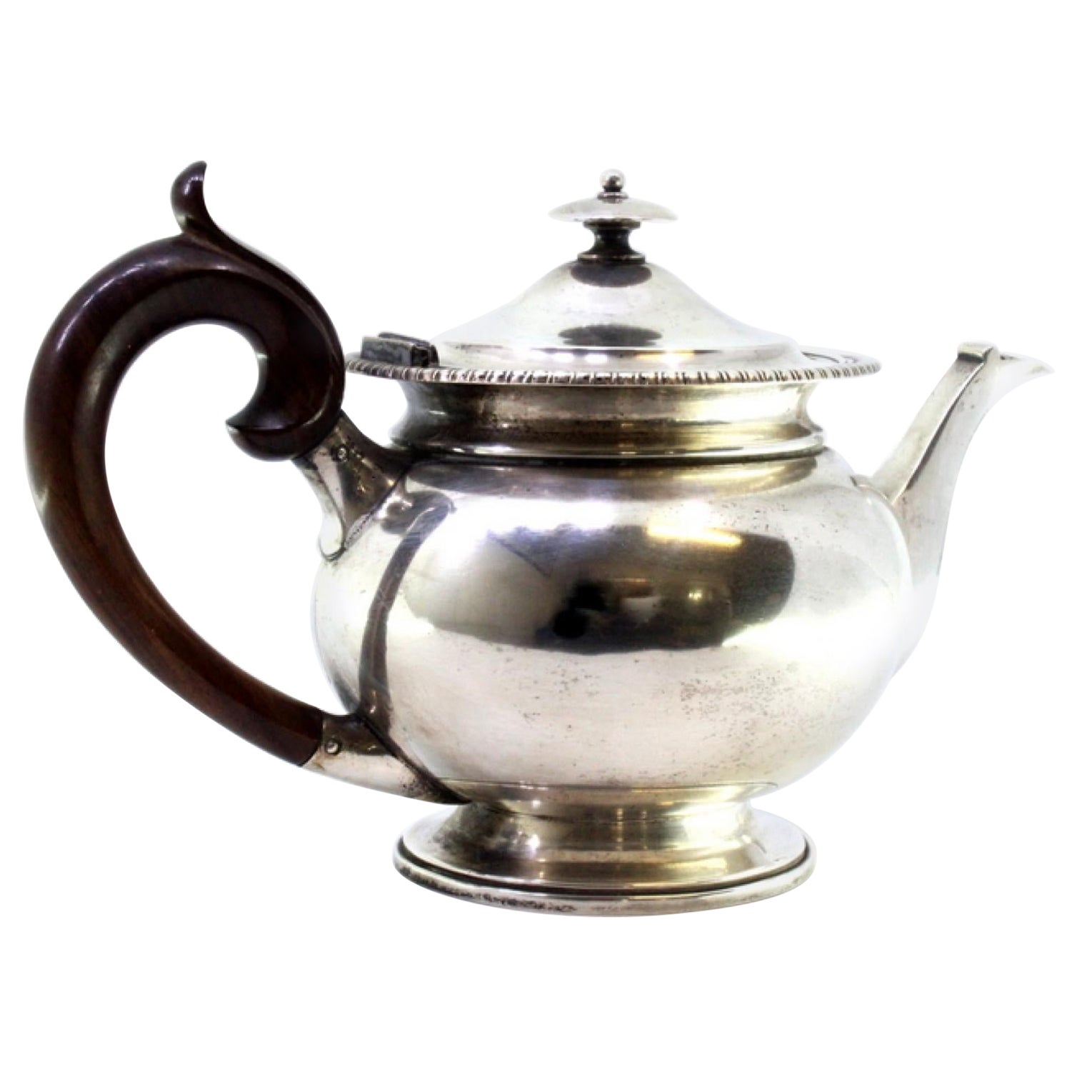 Silver kettle with raised friezes, hinged lid with wood knob and handle