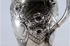 Silver kettle with reliefs and on the handle of the removable lid