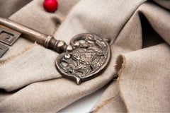 Silver key cut and crowned with English symbols