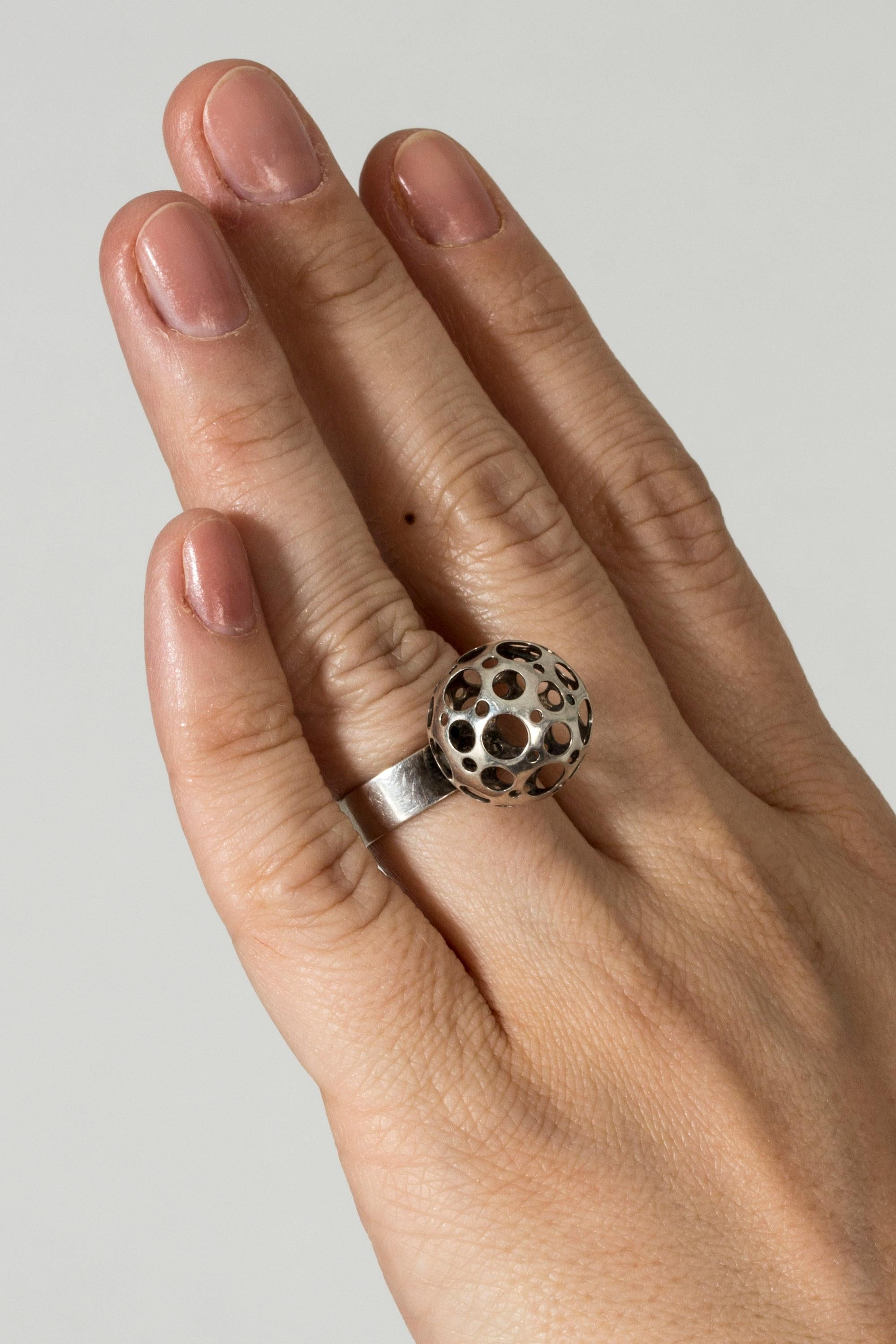 Beautiful silver “Ladybird” ring by Liisa Vitali, with an airy sphere perforated with holes. Lovely playful design.