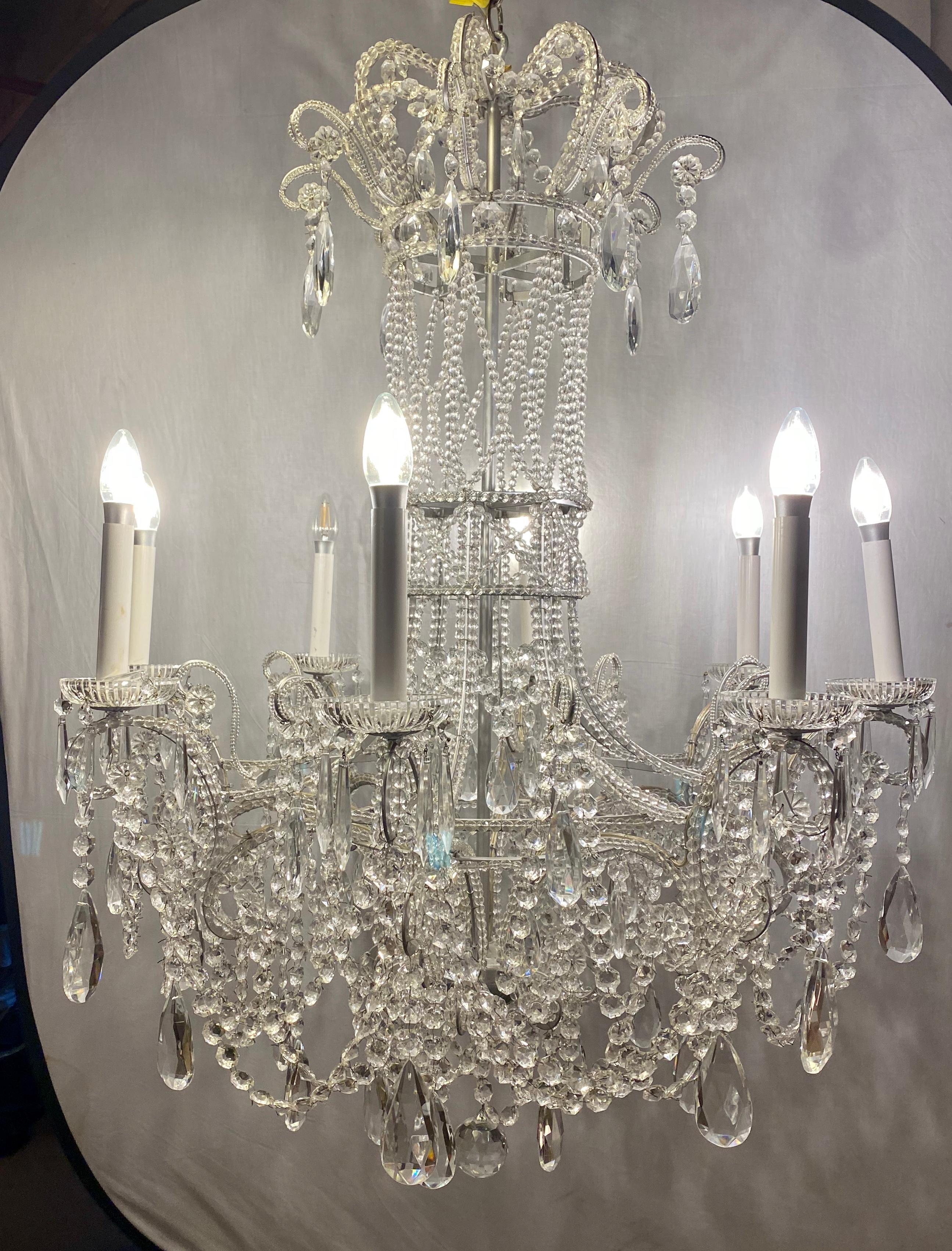 A continental silver leaf iron chandelier with fine crystal bead and pendant decoration. Quality rises up on this all crystal decorated chandelier. Large and impressive iron frame that is totally covered in cut crystals with a basket form column