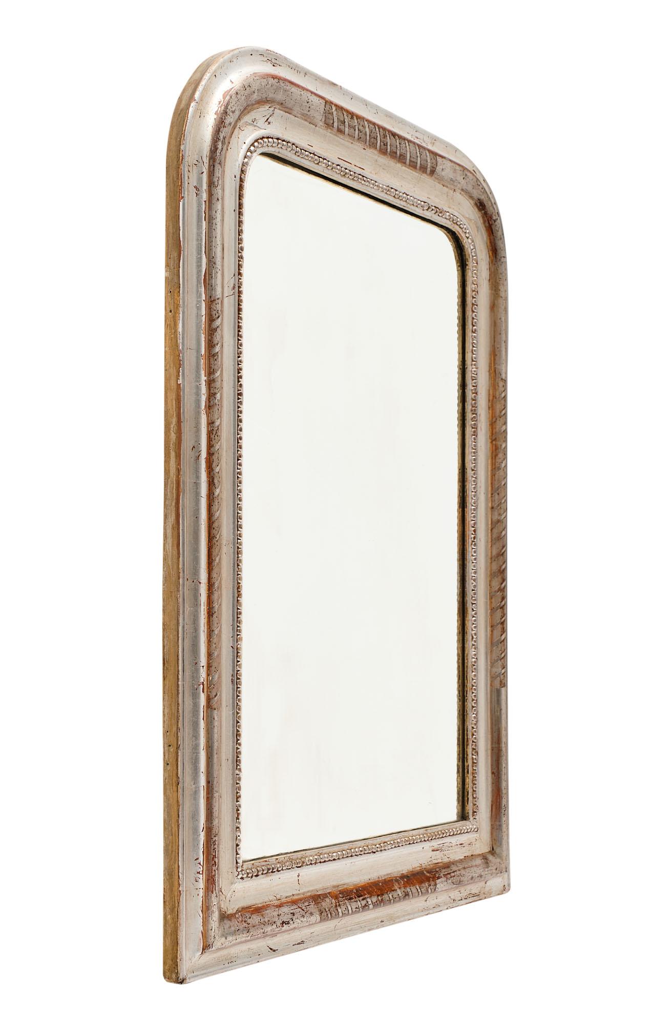 Silver leaf Louis Philippe period mirror with a wood and gesso frame that has hand-chiseled details and the beautiful sienna colored glaze showing through the silver leafing.